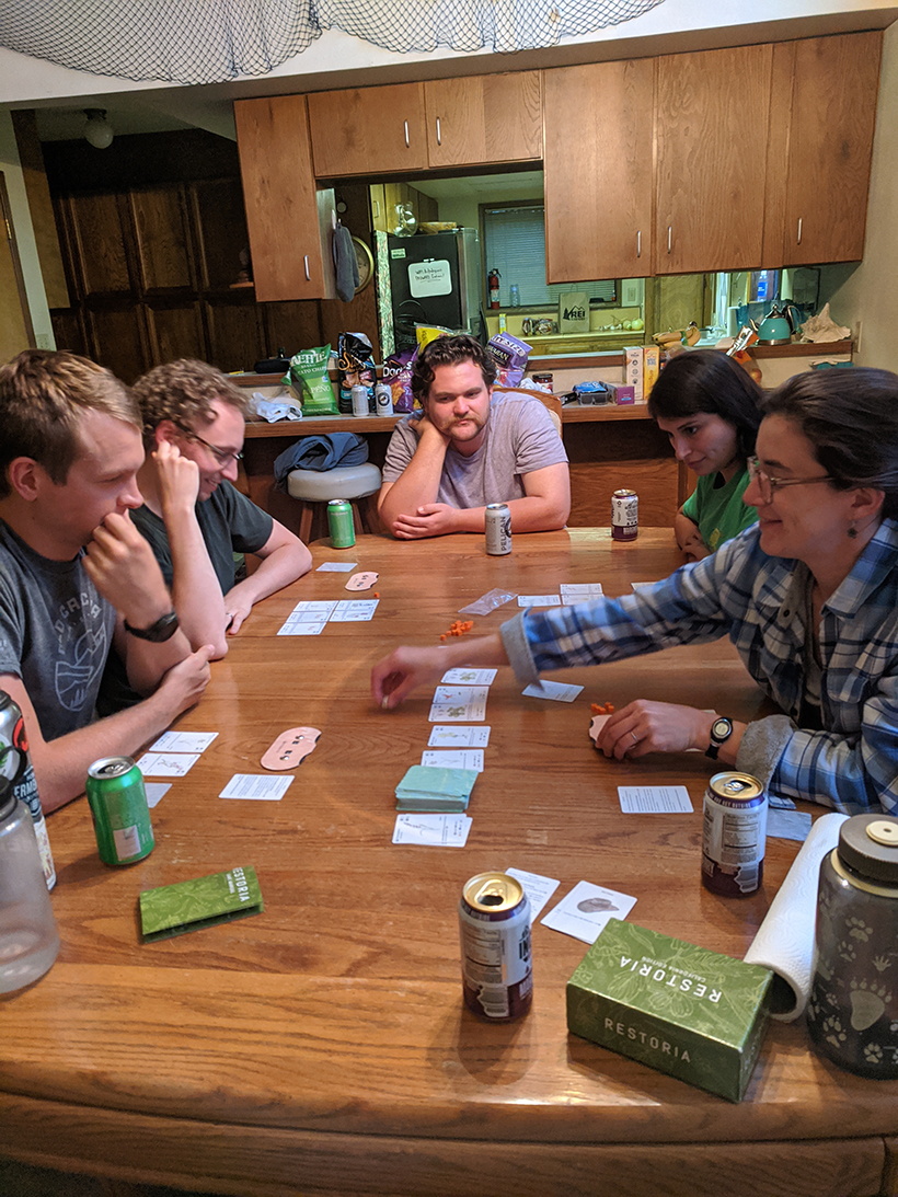 People playing Restoria at a lab retreat